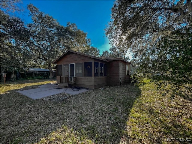 exterior space with a front lawn and a patio area