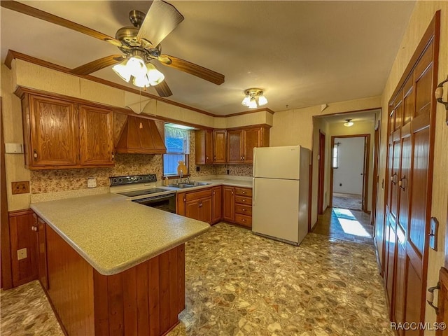 kitchen with sink, custom exhaust hood, kitchen peninsula, white fridge, and range with electric cooktop