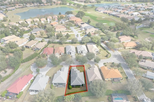 bird's eye view featuring golf course view, a water view, and a residential view