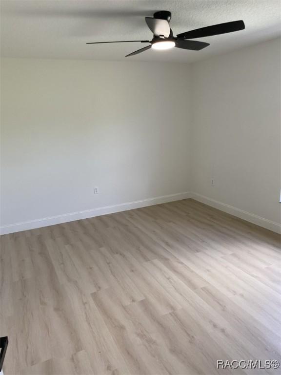 259 N Cherry Pop Dr, Inverness, FL 34453 - unfurnished room featuring a ceiling fan, wood finished floors, and baseboards