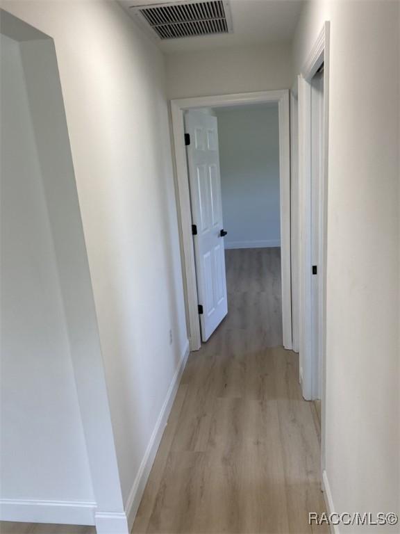 259 N Cherry Pop Dr, Inverness, FL 34453 - hall with light wood-style floors and baseboards