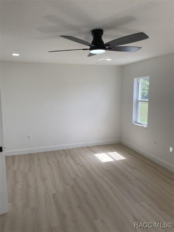 259 N Cherry Pop Dr, Inverness, FL 34453 - spare room with light wood-style flooring, baseboards, and ceiling fan
