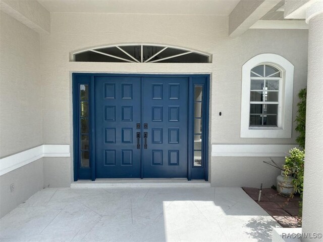 259 N Cherry Pop Dr, Inverness, FL 34453 - entrance to property featuring stucco siding and a garage