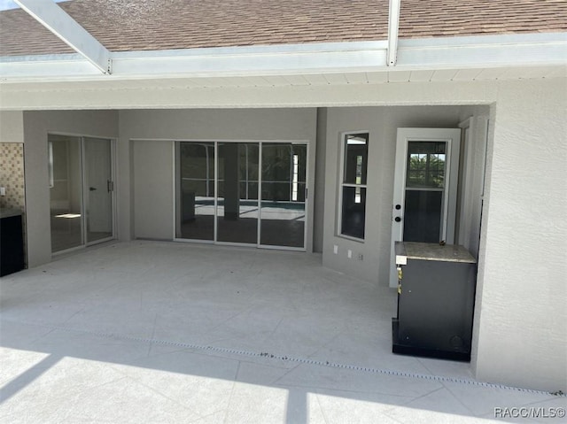 259 N Cherry Pop Dr, Inverness, FL 34453 - property entrance with a shingled roof, a patio, and stucco siding