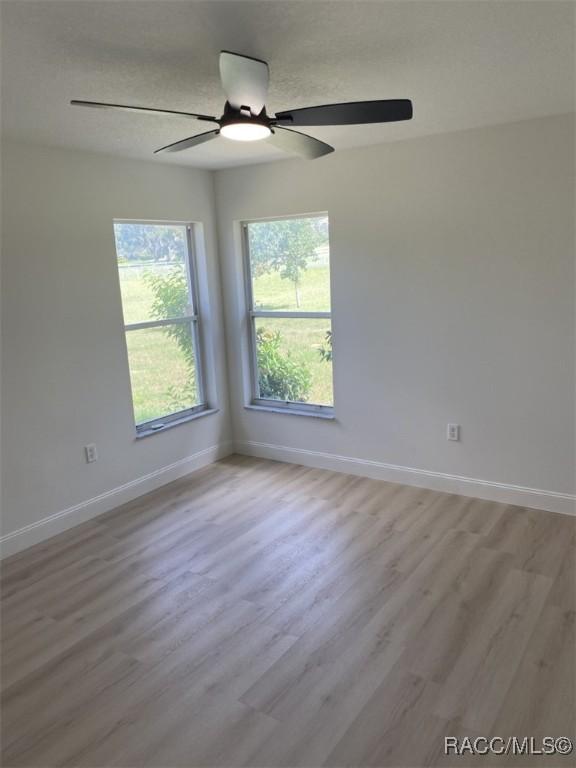 259 N Cherry Pop Dr, Inverness, FL 34453 - unfurnished room featuring a ceiling fan, baseboards, and wood finished floors