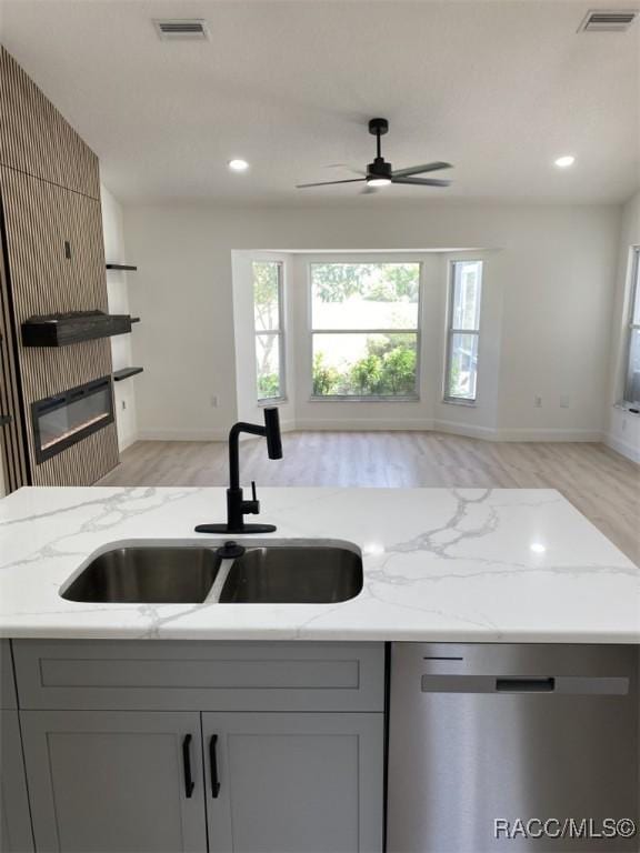 259 N Cherry Pop Dr, Inverness, FL 34453 - kitchen with a sink, dishwasher, gray cabinetry, light wood-type flooring, and recessed lighting