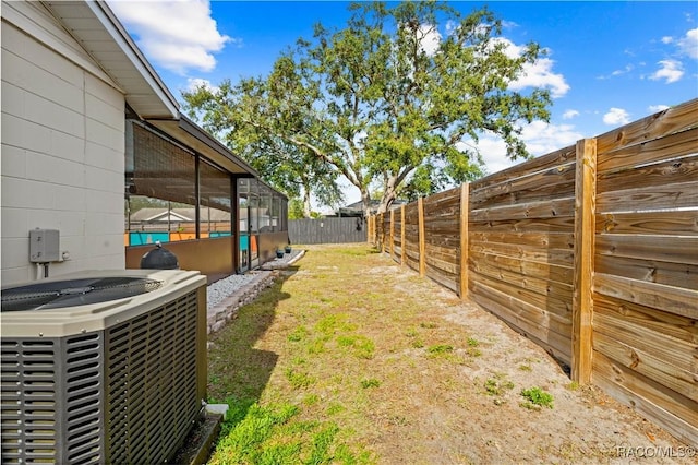 view of yard with a lanai and cooling unit