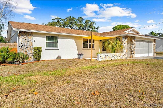 ranch-style home with a garage and a front yard