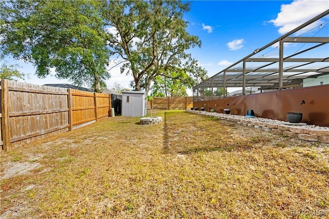 view of yard with a lanai and a storage shed