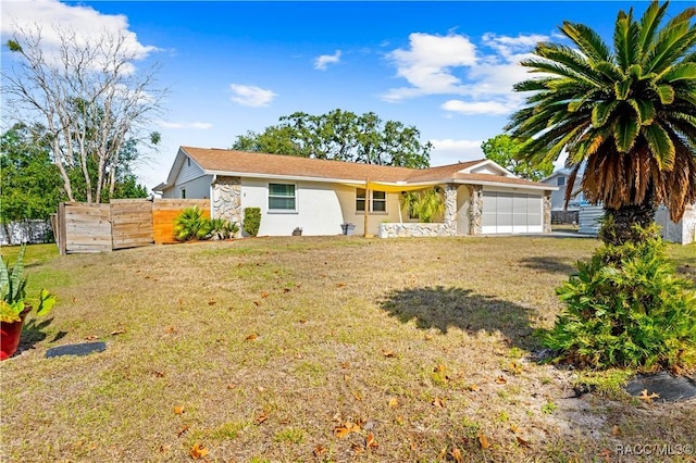 ranch-style home featuring a front lawn and a garage