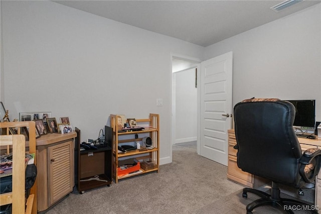 office space featuring light carpet, baseboards, and visible vents