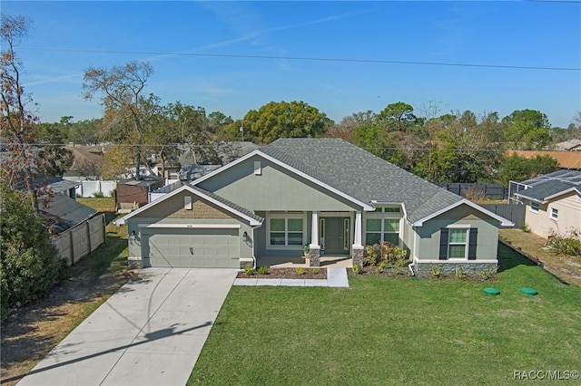 view of front of property featuring a garage, a front yard, concrete driveway, and stucco siding