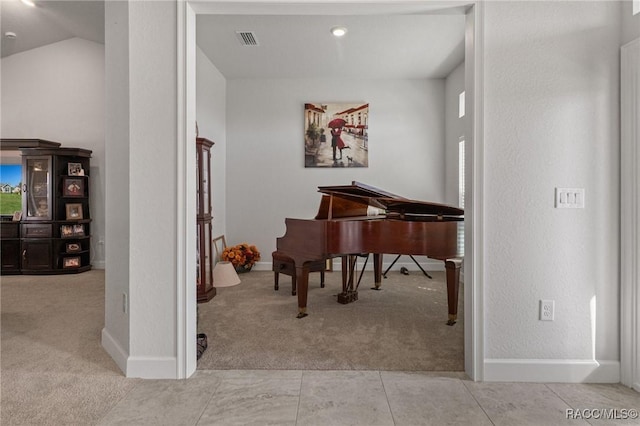 sitting room with light carpet, baseboards, visible vents, and vaulted ceiling