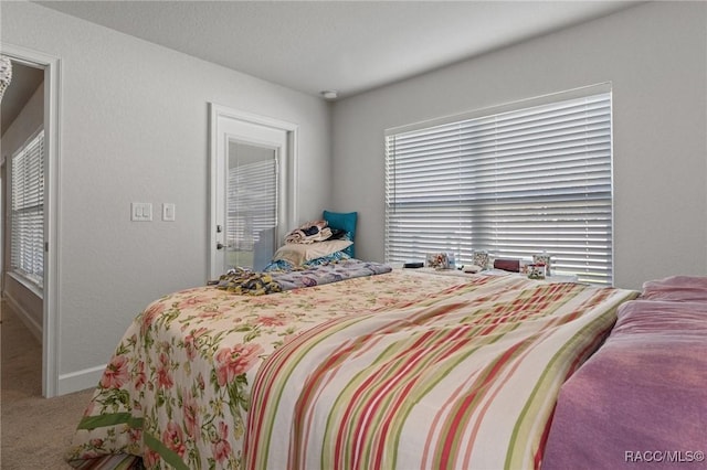 bedroom featuring carpet and baseboards