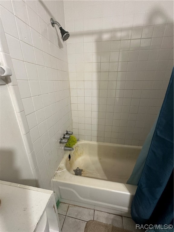 bathroom featuring tile patterned floors and shower / bath combo with shower curtain