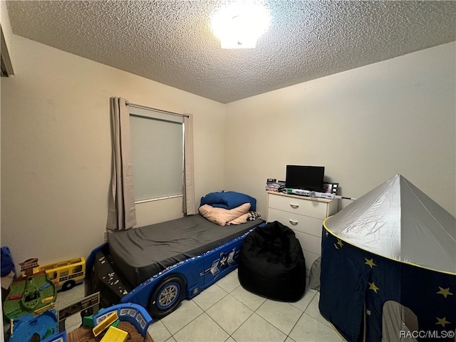 tiled bedroom with a textured ceiling