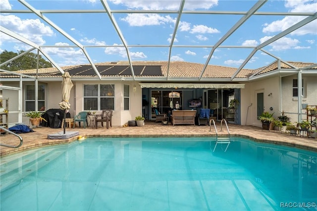 back of house featuring glass enclosure and a patio