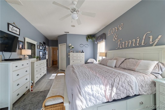 bedroom featuring ceiling fan, a closet, and hardwood / wood-style flooring