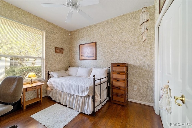 bedroom with ceiling fan, a closet, and dark wood-type flooring