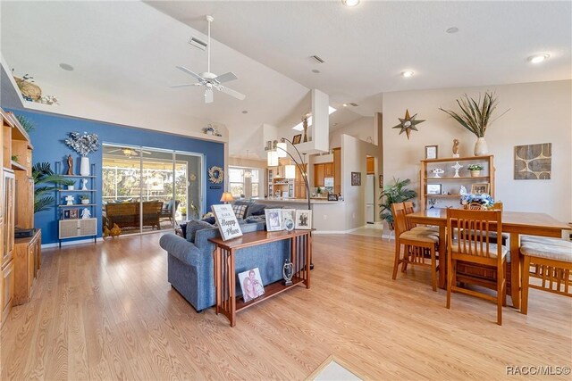 entryway with light hardwood / wood-style floors, vaulted ceiling, and french doors