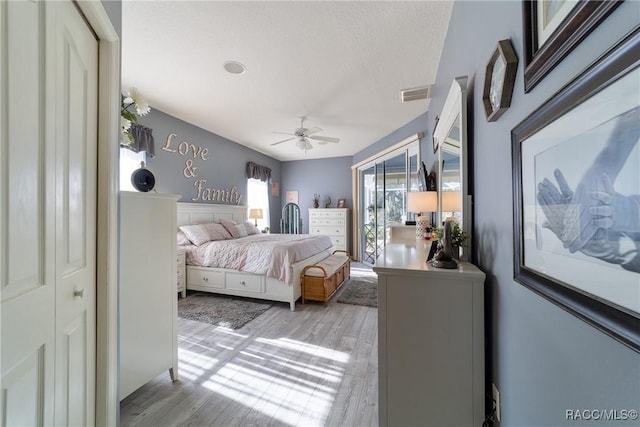 bedroom featuring access to exterior, ceiling fan, and light hardwood / wood-style floors