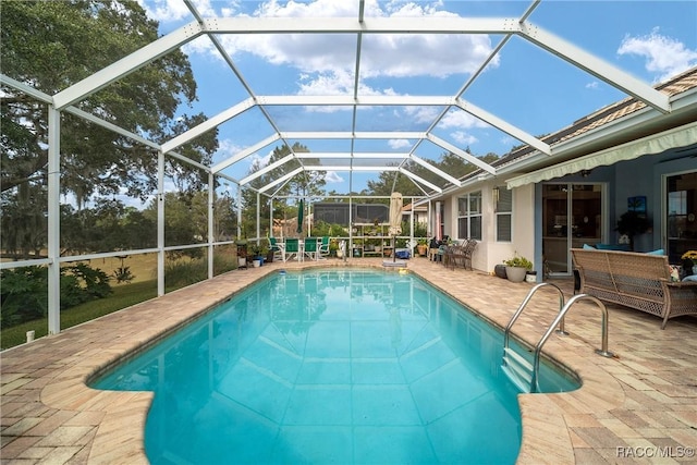 view of pool featuring a lanai and a patio area