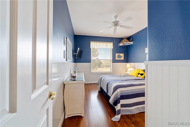 bedroom with ceiling fan and dark wood-type flooring