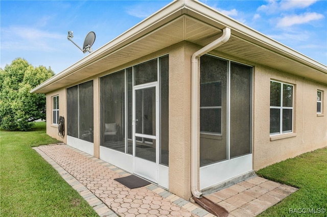 2459 N Brentwood Cir, Lecanto, FL 34461 - view of side of home with a sunroom, stucco siding, and a yard