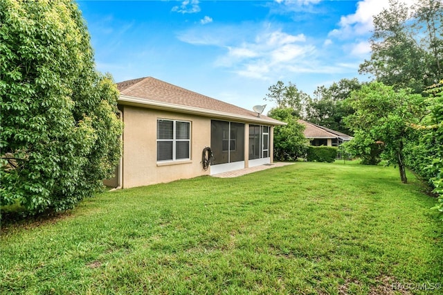 2459 N Brentwood Cir, Lecanto, FL 34461 - rear view of property with stucco siding, a lawn, and a sunroom