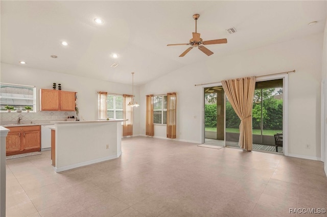 2459 N Brentwood Cir, Lecanto, FL 34461 - kitchen featuring healthy amount of natural light, vaulted ceiling, light countertops, backsplash, and a ceiling fan