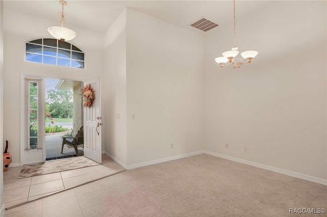 2459 N Brentwood Cir, Lecanto, FL 34461 - entryway with a chandelier, a high ceiling, and light tile patterned floors