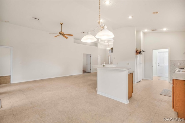2459 N Brentwood Cir, Lecanto, FL 34461 - kitchen featuring freestanding refrigerator, ceiling fan, light countertops, a high ceiling, and pendant lighting