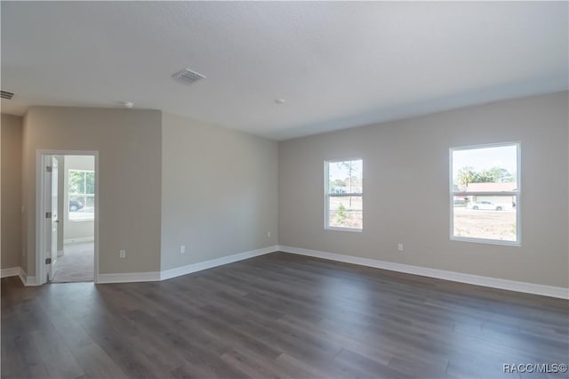 unfurnished room featuring dark hardwood / wood-style flooring