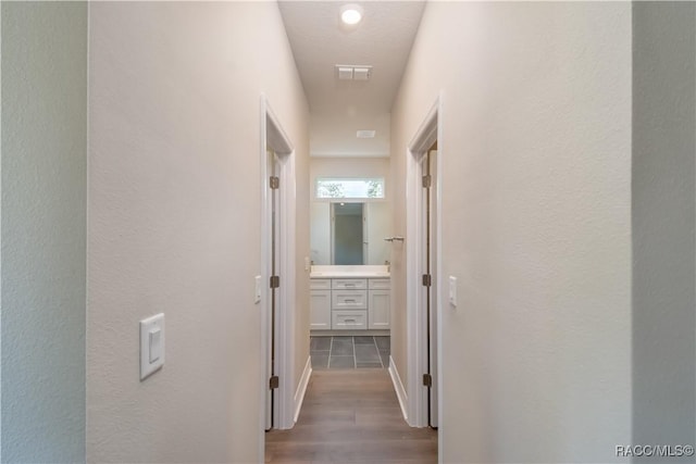 hallway with dark hardwood / wood-style flooring