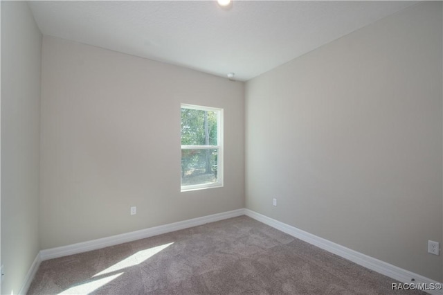 unfurnished room featuring light carpet