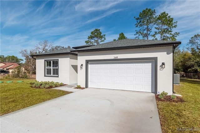 ranch-style house with a garage, central AC unit, and a front yard