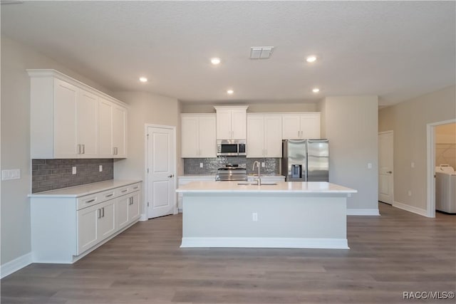 kitchen with stainless steel appliances, white cabinetry, and sink