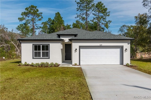 view of front of house featuring a garage and a front lawn