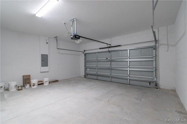 garage with a garage door opener and electric panel