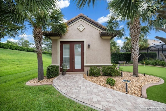 1462 N Ridge Meadow Path, Hernando, FL 34442 - property entrance with stucco siding, french doors, and a yard