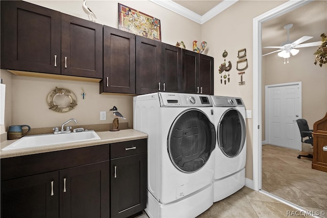 laundry area with cabinets, independent washer and dryer, crown molding, and sink