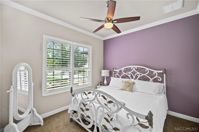 carpeted bedroom featuring ceiling fan and ornamental molding