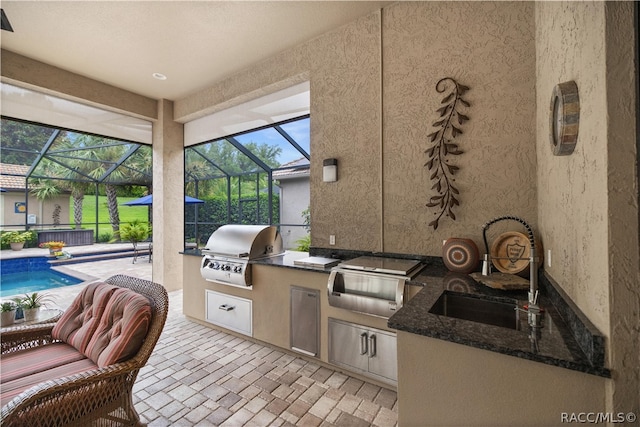 view of patio / terrace featuring a lanai, area for grilling, and sink