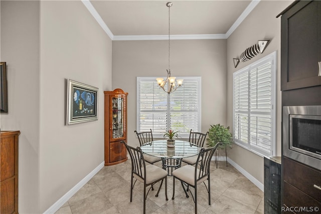 dining space featuring ornamental molding and a notable chandelier