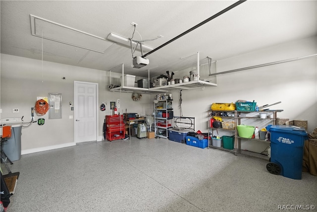 garage featuring electric panel and a garage door opener