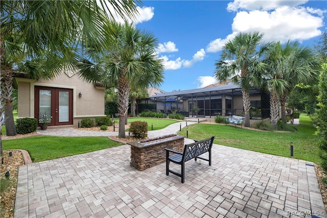 view of patio featuring a lanai and french doors