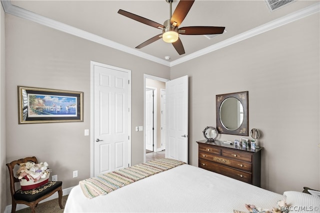 bedroom with carpet, ceiling fan, and ornamental molding