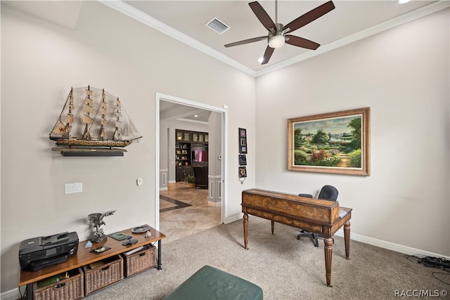 carpeted office space with ceiling fan and crown molding