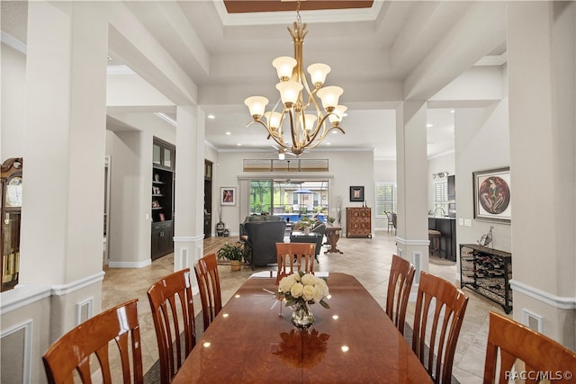 tiled dining space with a tray ceiling, a towering ceiling, a chandelier, and ornamental molding