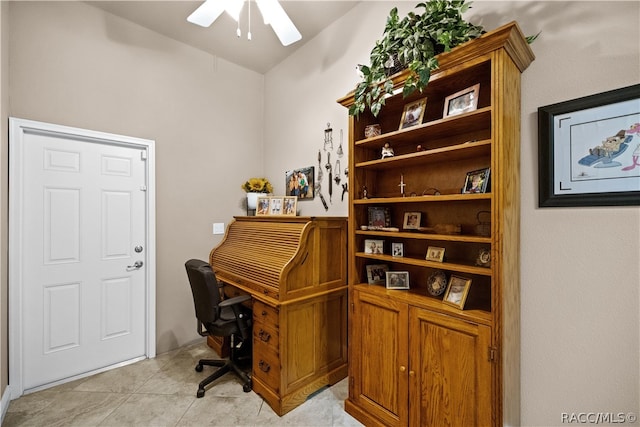 office area featuring ceiling fan, light tile patterned flooring, and lofted ceiling